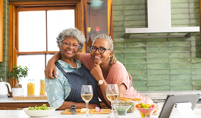 two women smiling in kitchen